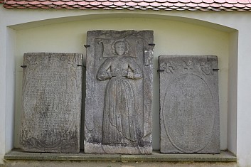 U muzejní zdi jsou uloženy náhrobní desky (IČ)
